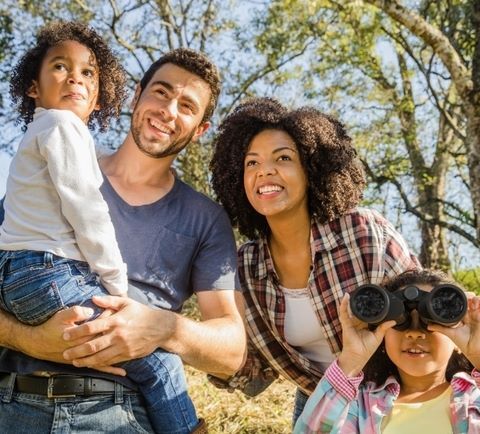 family smiling at the park